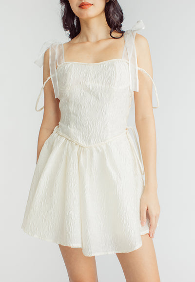 Elle Cream Textured Square Neck Sleeveless Self Tie Strap Pleated Mini Dress