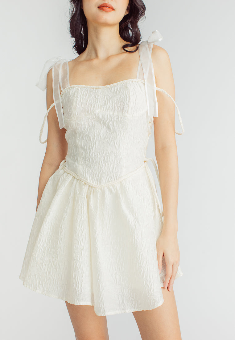 Elle Cream Textured Square Neck Sleeveless Self Tie Strap Pleated Mini Dress